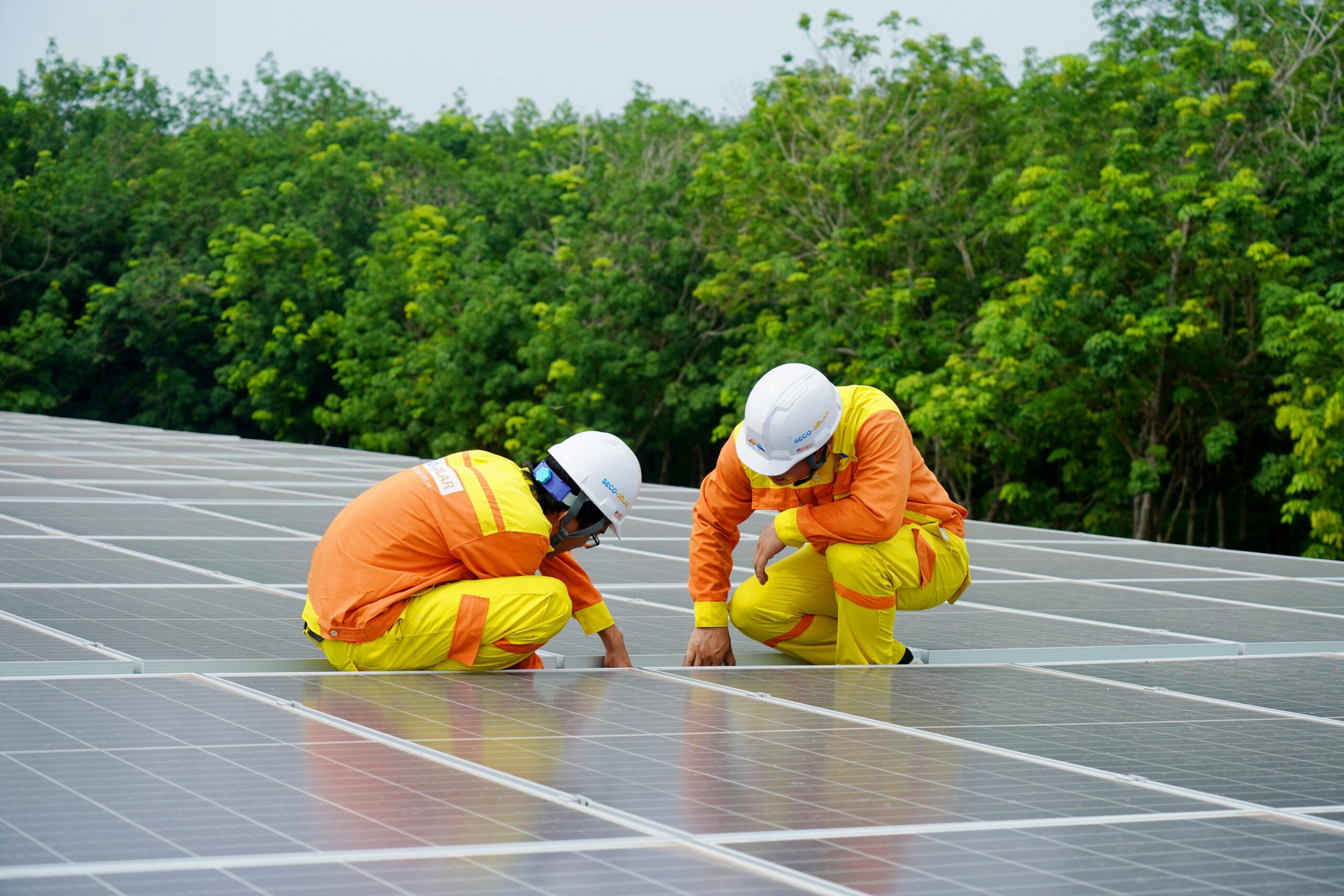 Engineers installing solar panels in Hyderabad with precision and safety.