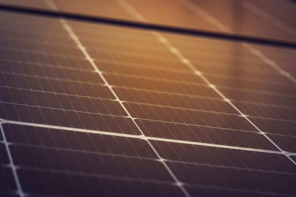 N-type TOPCON Bi-facial Solar panels during a Solar installation in Hyderabad pictured with sun's reflection across the panel