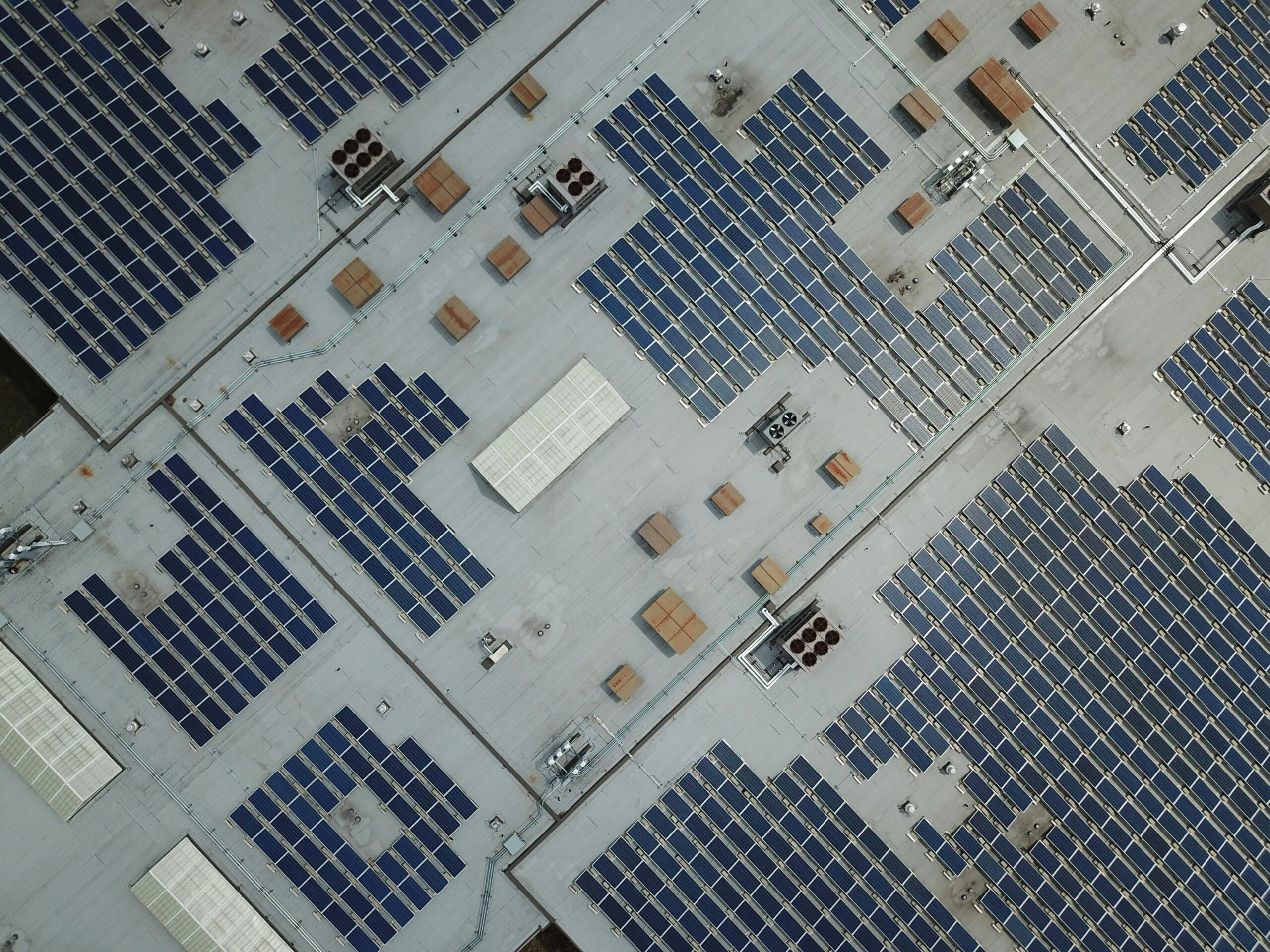 Drone shot of solar panels covering a building rooftop in Hyderabad showcasing renewable energy efforts.